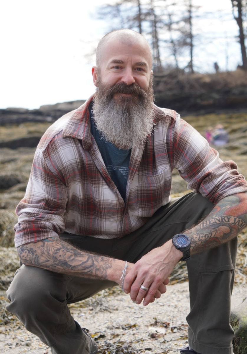 CHRISTOPHER R. HUNTLEY kneeling with flannel shirt on